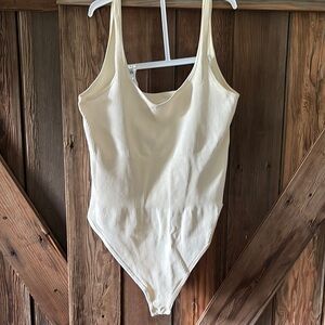 Cream Bodysuit with Scoop Neckline and High-Cut Legs